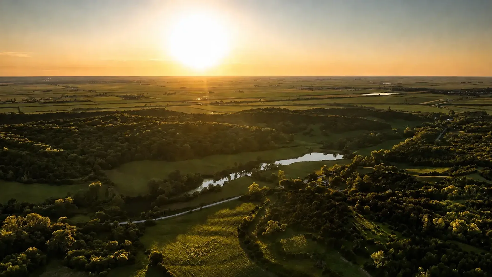 Sunset aerial view across the lakes, timber and open ground of the ranch