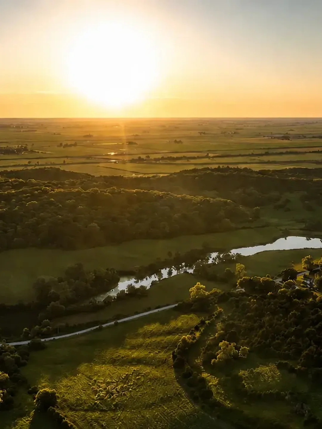 Sunset aerial view across the lakes, timber and open ground of LOESS LAKES RANCH